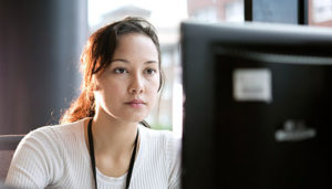 medical coder working at a computer